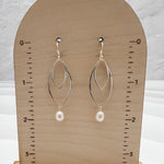 Lightweight sterling silver double marquis earrings with pearl drops measuring 2 inches in length on display stand