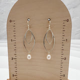 Lightweight sterling silver double marquis earrings with pearl drops measuring 2 inches in length on display stand