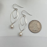 Handcrafted double marquis pearl drop earrings in sterling silver shown next to quarter for scale