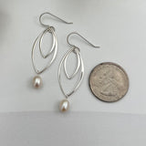 Handcrafted double marquis pearl drop earrings in sterling silver shown next to quarter for scale