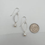 Sterling silver marquis pearl earrings next to dime showing 1.5 inch length and delicate size