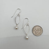 Sterling silver marquis pearl earrings next to dime showing 1.5 inch length and delicate size