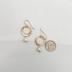 Small double hoop pearl earrings shown with dime for scale