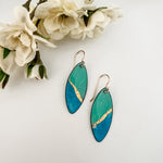  Seafoam green and blue enamel marquise drop earrings with 24k gold foil diagonal accent and 14k gold fill ear wires, styled with white fabric flowers