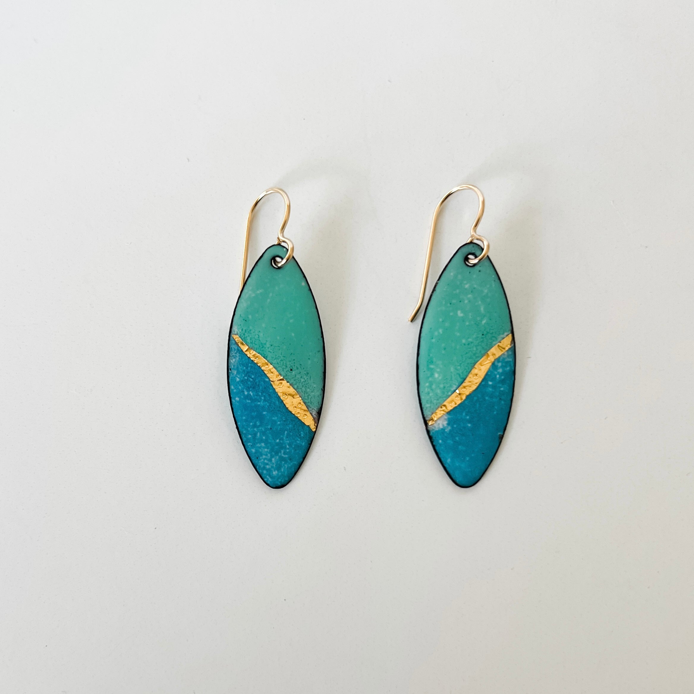 Handcrafted seafoam and ocean blue enamel earrings with textured gold foil inlay by Dawn Carlson Designs. 14 gold fill ear wires.