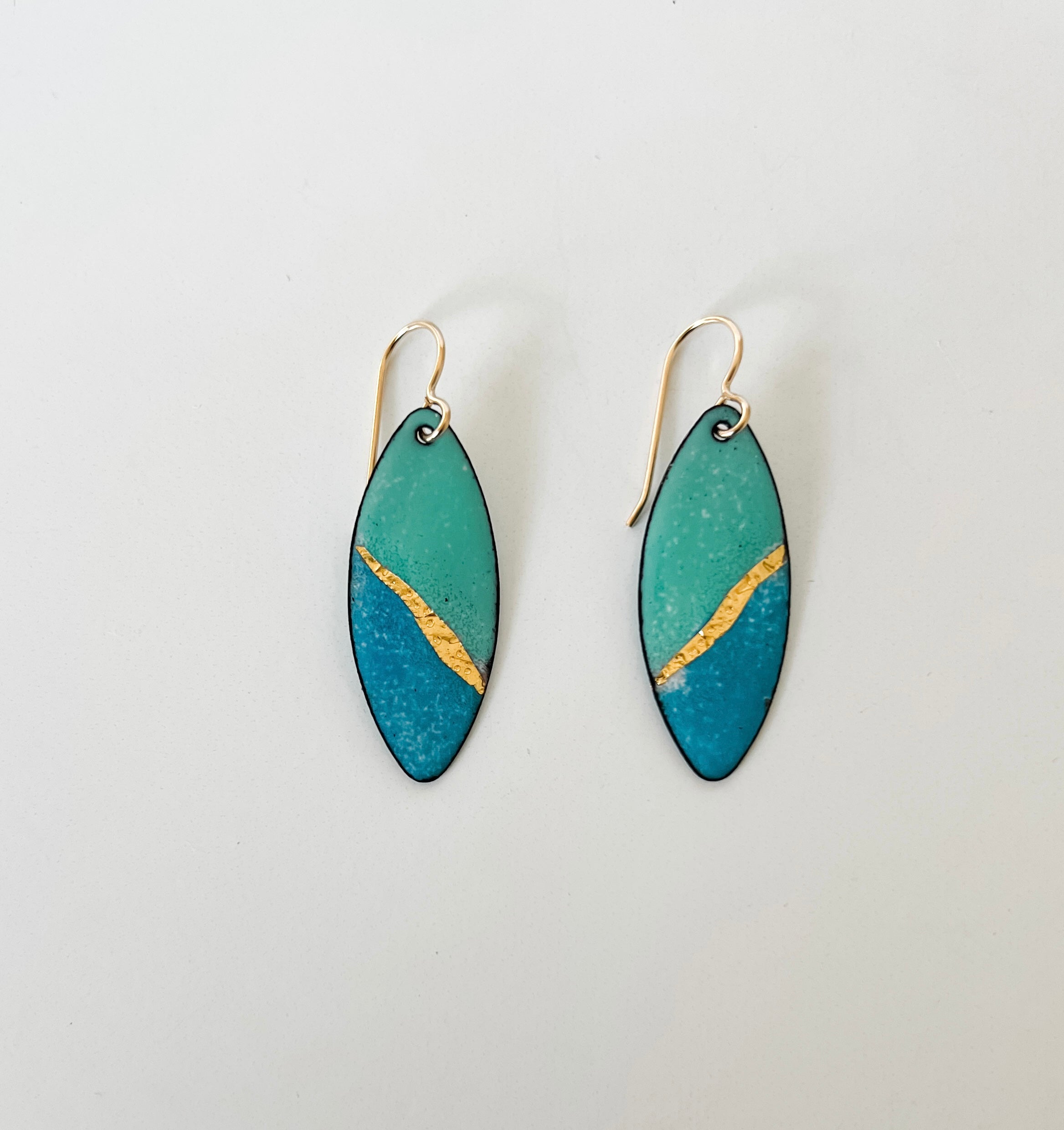 Handcrafted seafoam and ocean blue enamel earrings with textured gold foil inlay by Dawn Carlson Designs. 14 gold fill ear wires.